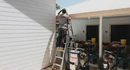 Professional roofing experts replacing commercial downpipe systems for efficient stormwater drainage across Sydney