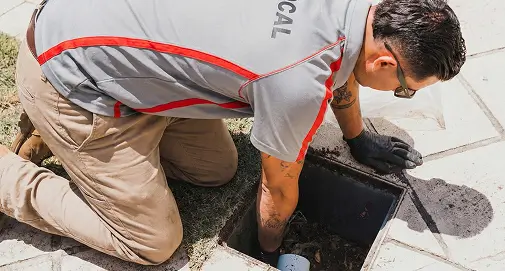 Experienced Sydney plumber cleaning and maintaining grease traps to ensure efficient wastewater flow and compliance