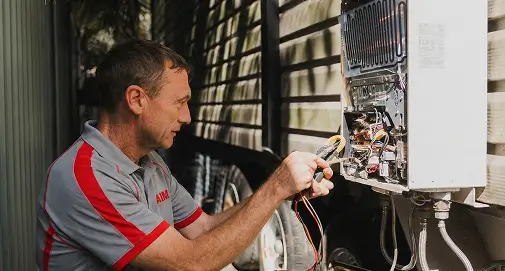 Professional plumbing specialist repairing and maintaining electric hot water heaters across Sydney