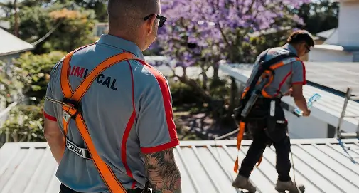 Experienced Sydney roofing specialist cleaning and repairing residential gutters to ensure efficient rainwater drainage